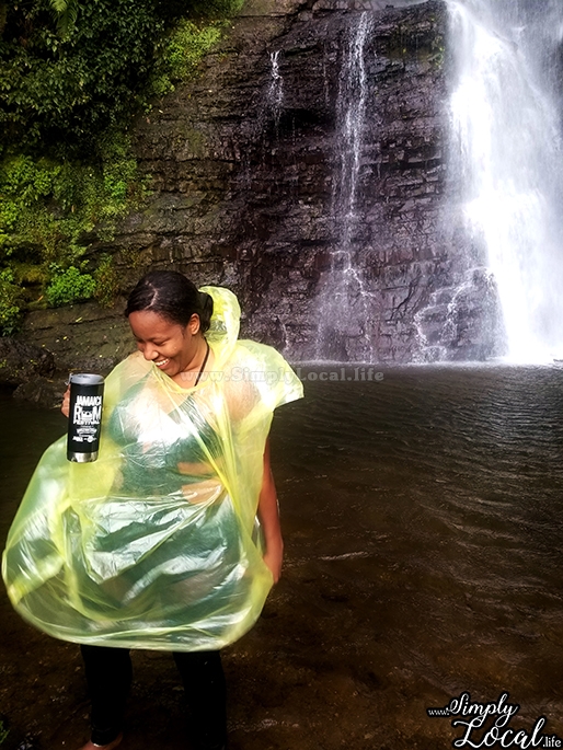girl in raincoat at waterfall