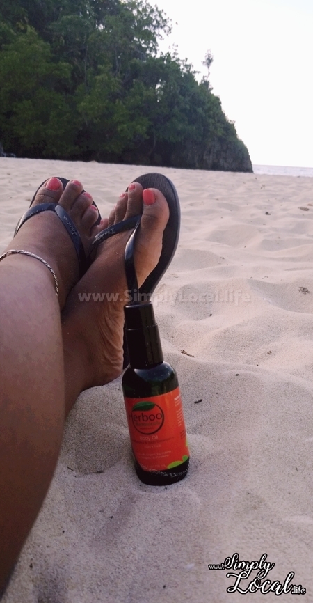 manicured toes on the beach with herboo body oil