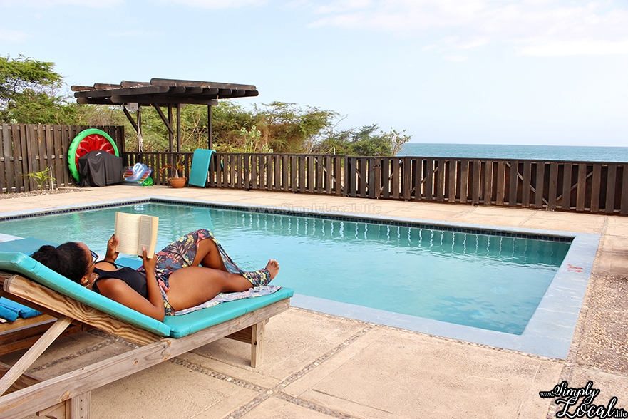 Turtles Nest Treasure Beach Jamaica Villa wome reading by pool