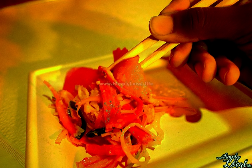 person using chopsticks sushi noodles